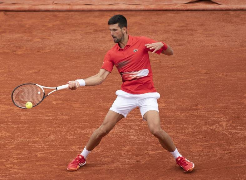 May 25, 2022; Paris, France; Novak Djokovic (SRB) returns a shot from Alex Molten (SVK)  during their match on day four of the French Open at Stade Roland-Garros. Mandatory Credit: Susan Mullane-USA TODAY Sports