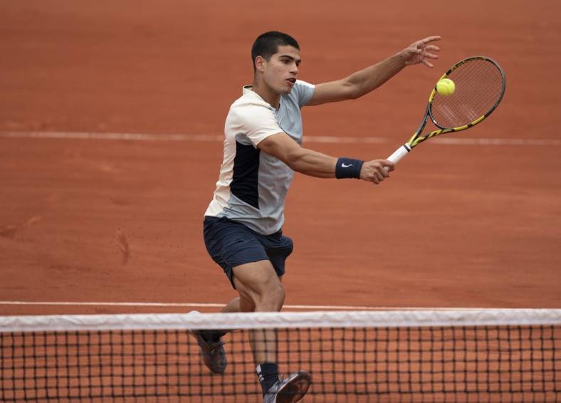 May 25, 2022; Paris, France; Carlos Alcaraz (ESP) returns a shot from Albert Ramos-Vinolas (ESP) during their match on day four of the French Open at Stade Roland-Garros. Mandatory Credit: Susan Mullane-USA TODAY Sports