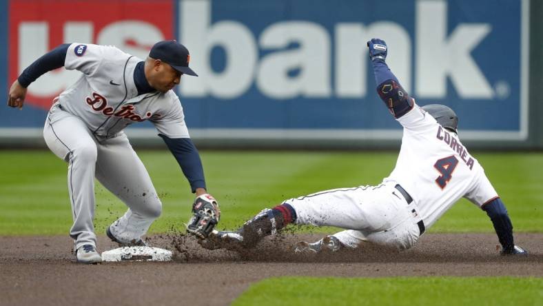 May 25, 2022; Minneapolis, Minnesota, USA; Minnesota Twins shortstop Carlos Correa (4) slides into second base ahead of the tag by Detroit Tigers second baseman Jonathan Schoop (7) for a double in the first inning at Target Field. Mandatory Credit: Bruce Kluckhohn-USA TODAY Sports