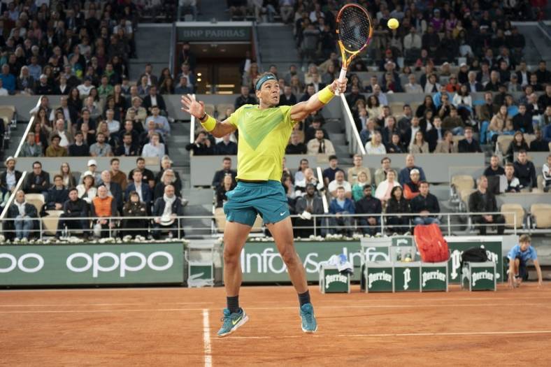May 25, 2022; Paris, France; Rafael Nadal (ESP) returns an overhead shot from Corentin Moutet (FRA) during their match on day four of the French Open at Stade Roland-Garros. Mandatory Credit: Susan Mullane-USA TODAY Sports