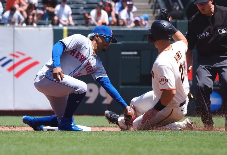 May 25, 2022; San Francisco, California, USA;  New York Mets shortstop Francisco Lindor (12) catches San Francisco Giants catcher Joey Bart (21) trying to steal second base during the first inning at Oracle Park. Mandatory Credit: Kelley L Cox-USA TODAY Sports