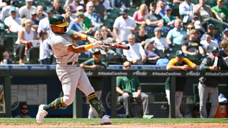 May 25, 2022; Seattle, Washington, USA; Oakland Athletics center fielder Cristian Pache (20) hits a double against the Seattle Mariners during the fifth inning at T-Mobile Park. Mandatory Credit: Steven Bisig-USA TODAY Sports