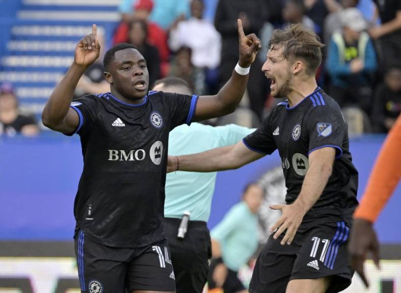May 25, 2022; Montreal, Quebec, Canada; CF Montreal forward Sunusi Ibrahim (14) celebrates with teammate midfielder Matko Miljevic (11) after scoring a goal against the Forge FC  during the first half at Stade Saputo. Mandatory Credit: Eric Bolte-USA TODAY Sports