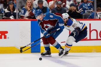 May 25, 2022; Denver, Colorado, USA; Colorado Avalanche defenseman Cale Makar (8) and St. Louis Blues left wing Brandon Saad (20) battle for the puck in the first period in game five of the second round of the 2022 Stanley Cup Playoffs at Ball Arena. Mandatory Credit: Isaiah J. Downing-USA TODAY Sports