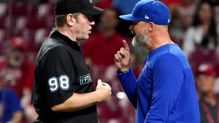 Umpire Chris Conroy (98) and Chicago Cubs manager David Ross (3) argue in the ninth inning during a baseball game between the Chicago Cubs and the Cincinnati Reds, Wednesday, May 25, 2022, at Great American Ball Park in Cincinnati.Chicago Cubs At Cincinnati Reds May 254 0026