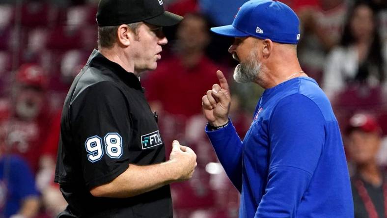 Umpire Chris Conroy (98) and Chicago Cubs manager David Ross (3) argue in the ninth inning during a baseball game between the Chicago Cubs and the Cincinnati Reds, Wednesday, May 25, 2022, at Great American Ball Park in Cincinnati.

Chicago Cubs At Cincinnati Reds May 254 0026