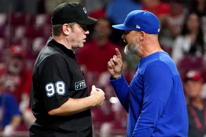 Umpire Chris Conroy (98) and Chicago Cubs manager David Ross (3) argue in the ninth inning during a baseball game between the Chicago Cubs and the Cincinnati Reds, Wednesday, May 25, 2022, at Great American Ball Park in Cincinnati.

Chicago Cubs At Cincinnati Reds May 254 0026