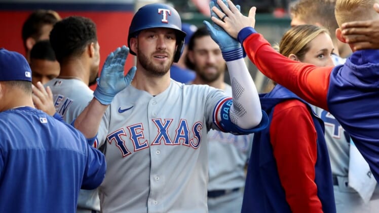 May 25, 2022; Anaheim, California, USA;  Texas Rangers designated hitter Mitch Garver (18) is congratulated by teammates after hitting a home run in the fourth inning against the Los Angeles Angels at Angel Stadium. Mandatory Credit: Kiyoshi Mio-USA TODAY Sports