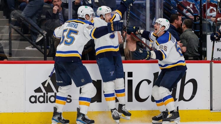 May 25, 2022; Denver, Colorado, USA; St. Louis Blues center Tyler Bozak (21) celebrates his game winning overtime goal against the Colorado Avalanche with defenseman Colton Parayko (55) and right wing Alexei Toropchenko (65) in game five of the second round of the 2022 Stanley Cup Playoffs at Ball Arena. Mandatory Credit: Isaiah J. Downing-USA TODAY Sports