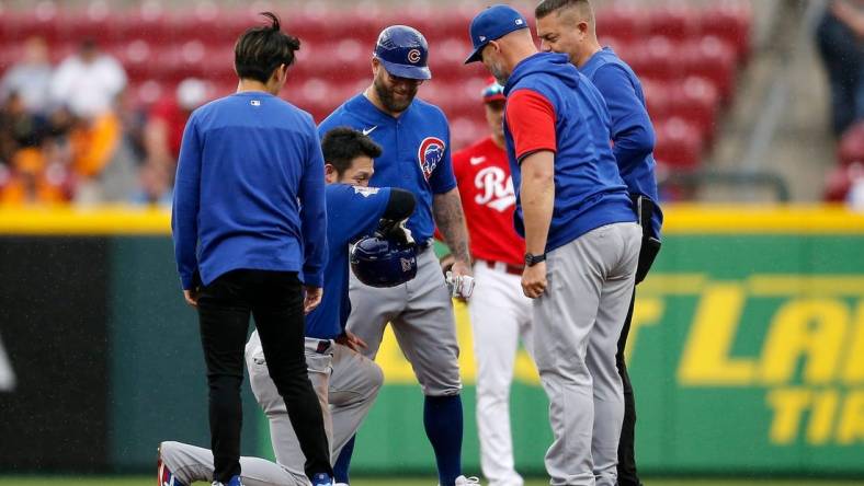 Chicago Cubs right fielder Seiya Suzuki (27) is checked by medical staff after sliding into second base in the third inning of the MLB National League game between the Cincinnati Reds and the Chicago Cubs at Great American Ball Park in downtown Cincinnati on Thursday, May 26, 2022. The Reds led 10-3 after three innings.

Chicago Cubs At Cincinnati Reds