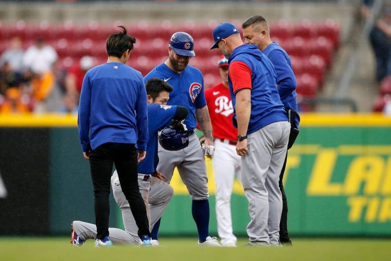 Chicago Cubs right fielder Seiya Suzuki (27) is checked by medical staff after sliding into second base in the third inning of the MLB National League game between the Cincinnati Reds and the Chicago Cubs at Great American Ball Park in downtown Cincinnati on Thursday, May 26, 2022. The Reds led 10-3 after three innings.

Chicago Cubs At Cincinnati Reds
