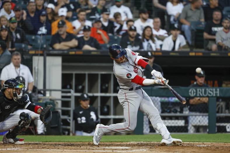 May 26, 2022; Chicago, Illinois, USA; Boston Red Sox second baseman Trevor Story (10) hits a three-run home run against the Chicago White Sox during the second inning at Guaranteed Rate Field. Mandatory Credit: Kamil Krzaczynski-USA TODAY Sports