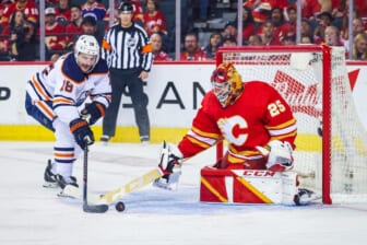 May 26, 2022; Calgary, Alberta, CAN; Calgary Flames goaltender Jacob Markstrom (25) makes a save against Edmonton Oilers left wing Zach Hyman (18) during the second period in game five of the second round of the 2022 Stanley Cup Playoffs at Scotiabank Saddledome. Mandatory Credit: Sergei Belski-USA TODAY Sports