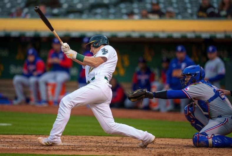 May 26, 2022; Oakland, California, USA; Oakland Athletics catcher Sean Murphy (12) hits a double during the fourth inning against the Texas Rangers at RingCentral Coliseum. Mandatory Credit: Neville E. Guard-USA TODAY Sports