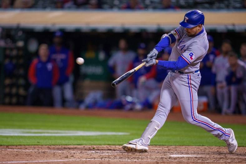 May 26, 2022; Oakland, California, USA; Texas Rangers first baseman Nathaniel Lowe (30) hits a two-run home run during the ninth inning against the Oakland Athletics at RingCentral Coliseum. Mandatory Credit: Neville E. Guard-USA TODAY Sports