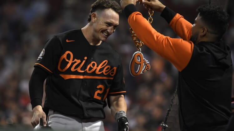 May 27, 2022; Boston, Massachusetts, USA; Baltimore Orioles right fielder Austin Hays (21) has a chain put around his neck after hitting a two run home run during the eighth inning against the Boston Red Sox at Fenway Park. Mandatory Credit: Bob DeChiara-USA TODAY Sports