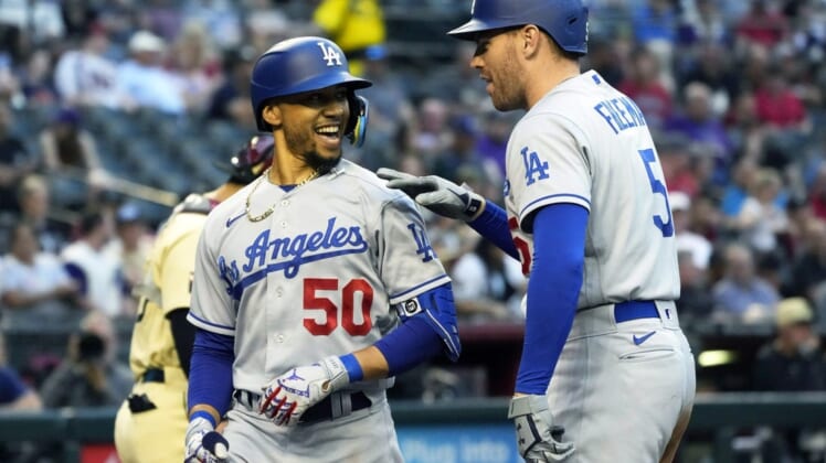 May 27, 2022; Phoenix, Arizona, USA; Los Angeles Dodgers right fielder Mookie Betts (50) celebrates with Freddie Freeman (5) after hitting a solo homerun against the Arizona Diamondbacks in the second inning at Chase Field. Mandatory Credit: Rick Scuteri-USA TODAY Sports