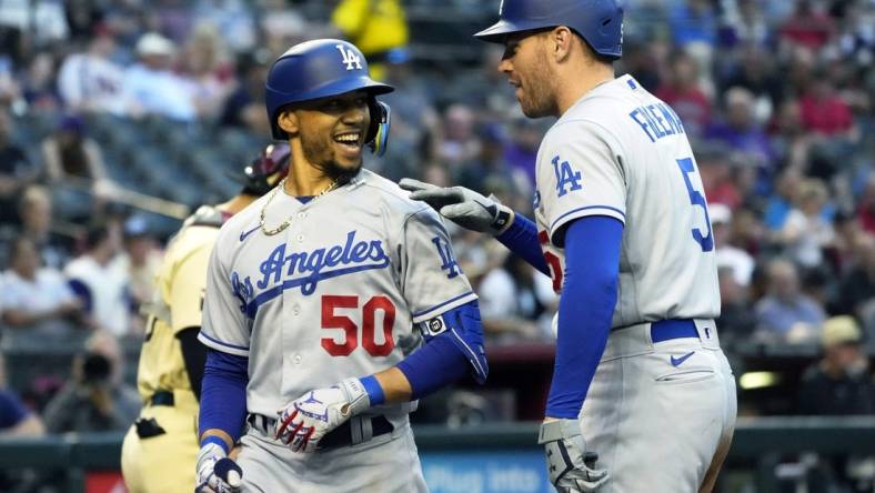 May 27, 2022; Phoenix, Arizona, USA; Los Angeles Dodgers right fielder Mookie Betts (50) celebrates with Freddie Freeman (5) after hitting a solo homerun against the Arizona Diamondbacks in the second inning at Chase Field. Mandatory Credit: Rick Scuteri-USA TODAY Sports