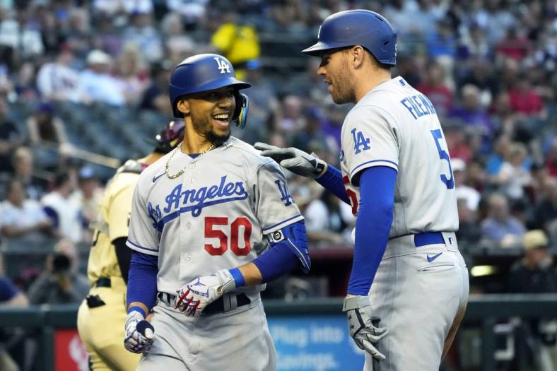 May 27, 2022; Phoenix, Arizona, USA; Los Angeles Dodgers right fielder Mookie Betts (50) celebrates with Freddie Freeman (5) after hitting a solo homerun against the Arizona Diamondbacks in the second inning at Chase Field. Mandatory Credit: Rick Scuteri-USA TODAY Sports