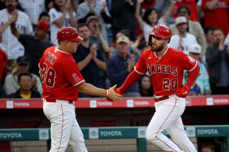 May 27, 2022; Anaheim, California, USA; Los Angeles Angels first baseman Jared Walsh (20) is congratulated by third base coach Phil Nevin (88) after hitting a home run in the third inning against Toronto Blue Jays at Angel Stadium. Mandatory Credit: Kiyoshi Mio-USA TODAY Sports