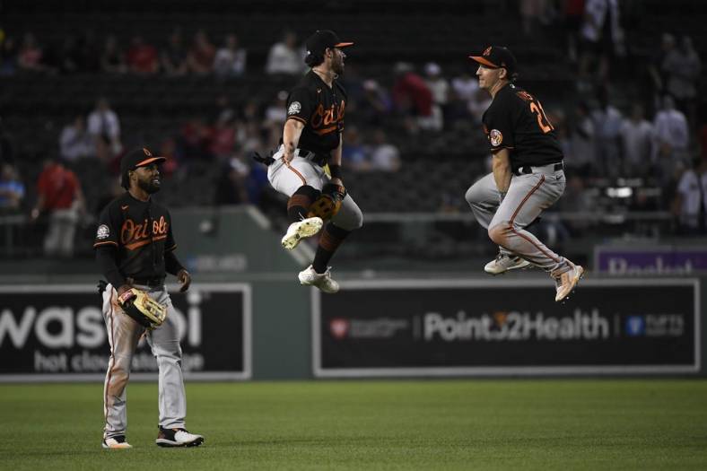 May 27, 2022; Boston, Massachusetts, USA;  Baltimore Orioles center fielder Ryan McKenna (26) and right fielder Trey Mancini (16) react while center fielder Cedric Mullins (31) looks on after the Orioles defeated the Boston Red Sox at Fenway Park. Mandatory Credit: Bob DeChiara-USA TODAY Sports