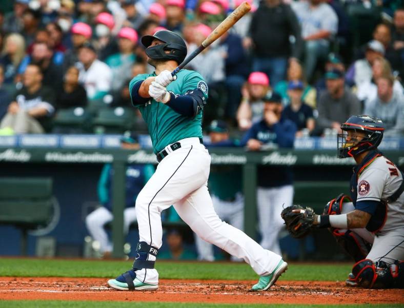 May 27, 2022; Seattle, Washington, USA;  Seattle Mariners first baseman Ty France (23) follows through on a home run against the Houston Astros during the third inning at T-Mobile Park. Mandatory Credit: Lindsey Wasson-USA TODAY Sports