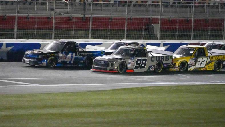 May 27, 2022; Concord, North Carolina, USA; NASCAR Camping World Truck Series driver Ross Chastain (41) moves ahead in the final restart with three laps to go ahead of  driver Christian Eckes (98) during the Education Lottery 200 at Charlotte Motor Speedway. Mandatory Credit: Jim Dedmon-USA TODAY Sports