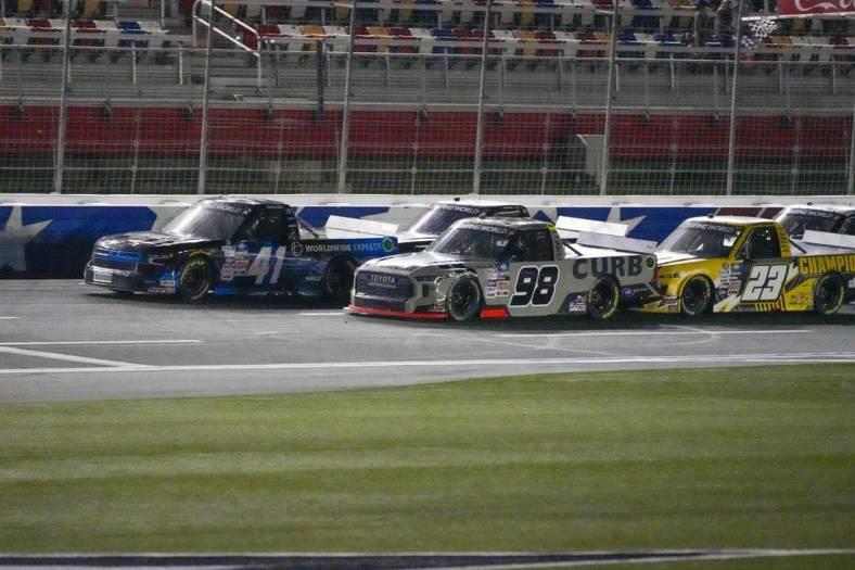 May 27, 2022; Concord, North Carolina, USA; NASCAR Camping World Truck Series driver Ross Chastain (41) moves ahead in the final restart with three laps to go ahead of  driver Christian Eckes (98) during the Education Lottery 200 at Charlotte Motor Speedway. Mandatory Credit: Jim Dedmon-USA TODAY Sports