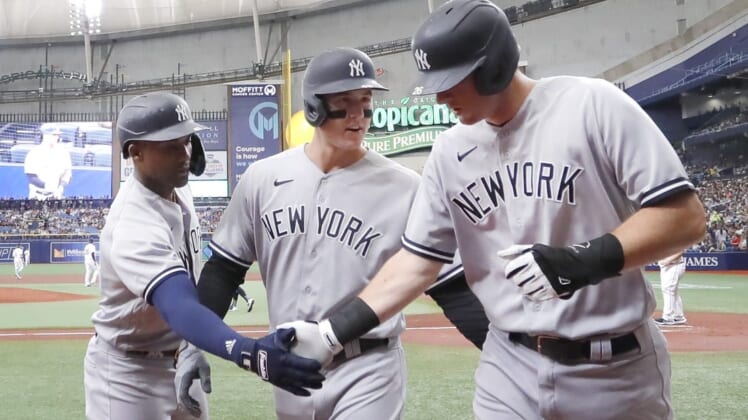 May 28, 2022; St. Petersburg, Florida, USA;  New York Yankees second baseman DJ LeMahieu, right, is congratulated on scoring by first baseman Anthony Rizzo (48) and second baseman Gleyber Torres, left, during the first inning against the Tampa Bay Rays at Tropicana Field. Mandatory Credit: Reinhold Matay-USA TODAY Sports