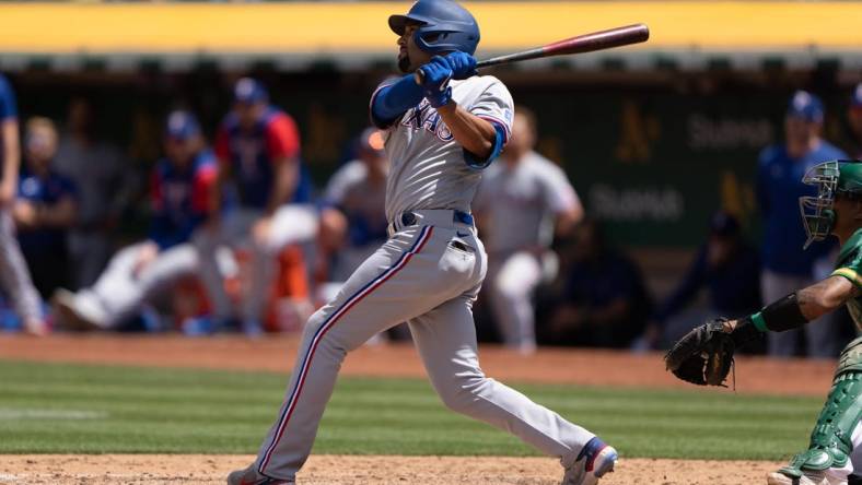 May 28, 2022; Oakland, California, USA; Texas Rangers second baseman Marcus Semien (2) hits a grand slam during the fifth inning against the Oakland Athletics at RingCentral Coliseum. Mandatory Credit: Stan Szeto-USA TODAY Sports