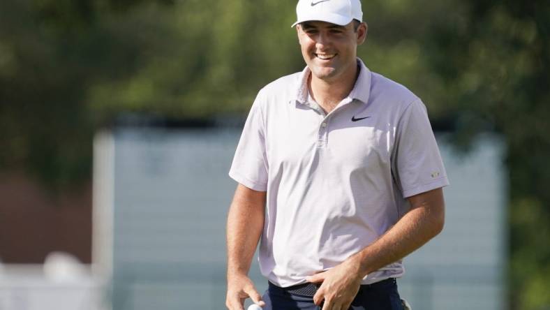 May 28, 2022; Fort Worth, Texas, USA; Scottie Scheffler smiles on the green after making a birdie on the 18th hole during the third round of the Charles Schwab Challenge golf tournament. Mandatory Credit: Raymond Carlin III-USA TODAY Sports