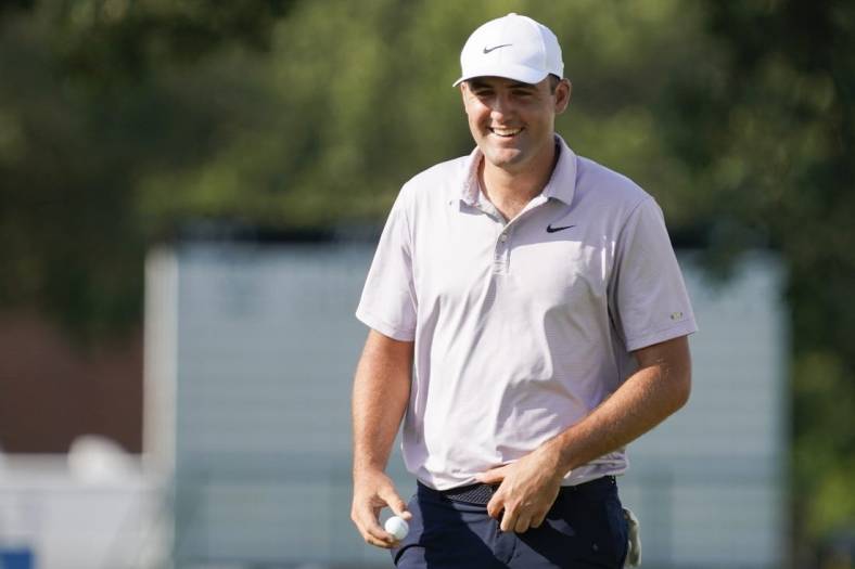May 28, 2022; Fort Worth, Texas, USA; Scottie Scheffler smiles on the green after making a birdie on the 18th hole during the third round of the Charles Schwab Challenge golf tournament. Mandatory Credit: Raymond Carlin III-USA TODAY Sports