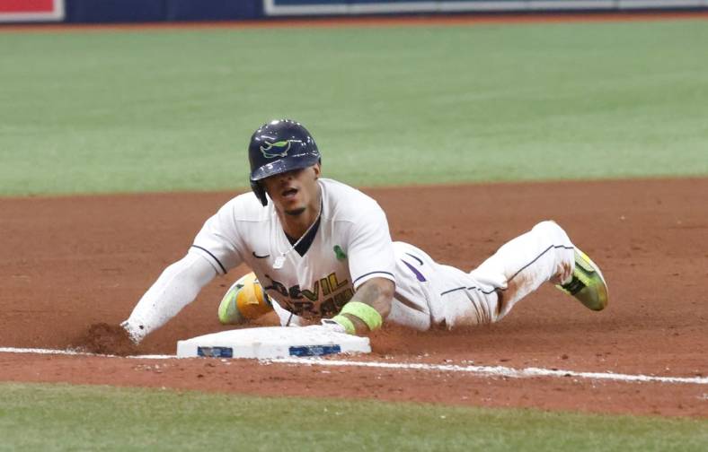 May 28, 2022; St. Petersburg, Florida, USA;  Tampa Bay Rays shortstop Wander Franco (5) slides into third base after hitting a triple during the eighth inning against the New York Yankees at Tropicana Field. Mandatory Credit: Reinhold Matay-USA TODAY Sports