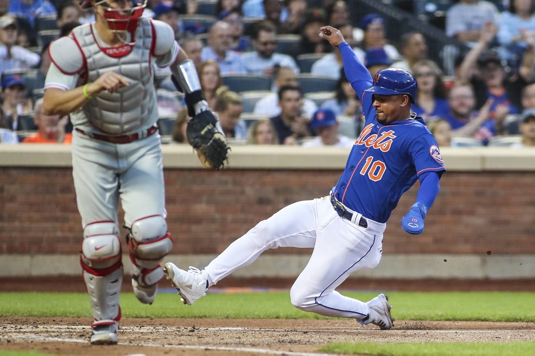 May 28, 2022; New York City, New York, USA;  New York Mets third baseman Eduardo Escobar (10) slides into home plate to score against the Philadelphia Phillies in the second inning at Citi Field. Mandatory Credit: Wendell Cruz-USA TODAY Sports