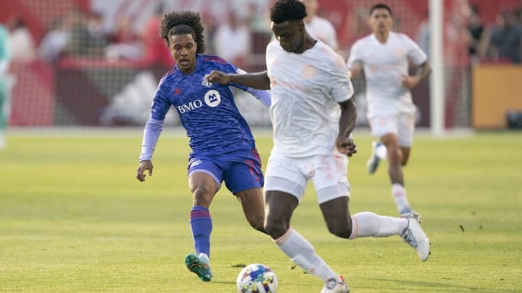 May 28, 2022; Toronto, Ontario, CAN; Chicago Fire defender Carlos Teran (23) battles for the ball against Toronto FC forward Jayden Nelson (11) during the first half at BMO Field. Mandatory Credit: Nick Turchiaro-USA TODAY Sports