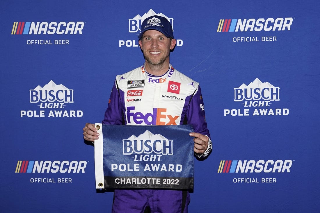 May 28, 2022; Concord, North Carolina, USA; NASCAR Cup Series driver Denny Hamlin poses for a picture after winning the pole for the Coca-Cola 600 at Charlotte Motor Speedway. Mandatory Credit: Jasen Vinlove-USA TODAY Sports