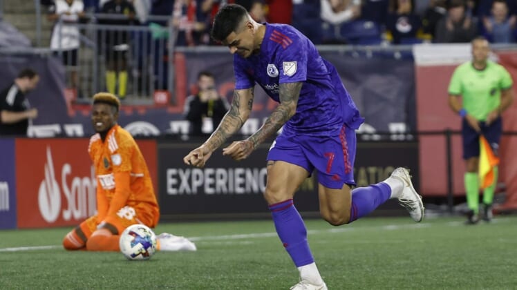 May 28, 2022; Foxborough, Massachusetts, USA; New England Revolution forward Gustavo Bou (7) celebrates his penalty goal against Philadelphia Union goalkeeper Andre Blake (18) during the second half at Gillette Stadium. Mandatory Credit: Winslow Townson-USA TODAY Sports