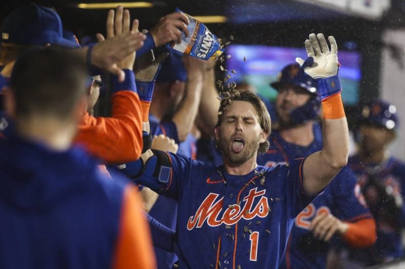 May 28, 2022; New York City, New York, USA;  New York Mets left fielder Jeff McNeil (1) is greeted in the dugout after hitting a three run home against the Philadelphia Phillies in the fourth inning at Citi Field. Mandatory Credit: Wendell Cruz-USA TODAY Sports