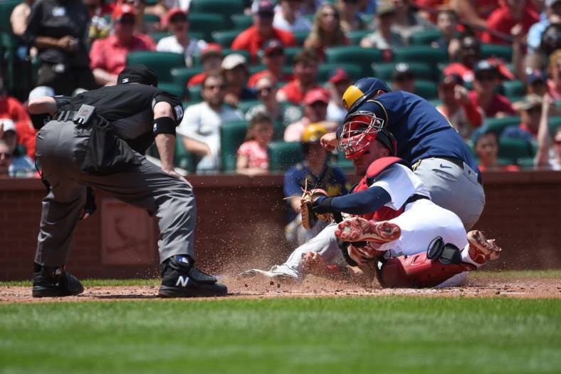 May 29, 2022; St. Louis, Missouri, USA; Milwaukee Brewers first baseman Rowdy Tellez (11) is tagged out by St. Louis Cardinals catcher Andrew Knizner (7) during the fourth inning at Busch Stadium. Mandatory Credit: Joe Puetz-USA TODAY Sports