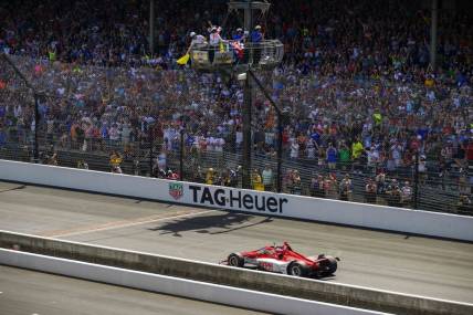 May 29, 2022; Indianapolis, Indiana, USA; Chip Ganassi Racing driver Marcus Ericsson (8) of Sweden crosses the finish line and wins the106th running of the Indianapolis 500 at Indianapolis Motor Speedway. Mandatory Credit: Jerome Miron-USA TODAY Sports