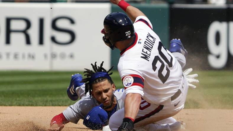 May 29, 2022; Chicago, Illinois, USA; Chicago Cubs second baseman Andrelton Simmons (19) forces out Chicago White Sox shortstop Danny Mendick (20) at second base during the sixth inning at Guaranteed Rate Field. Mandatory Credit: David Banks-USA TODAY Sports