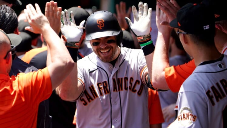 San Francisco Giants third baseman Evan Longoria (10) is congratulated in the dugout after hitting a three-run home run to give the San Francisco Giants the lead in the eighth inning during a baseball game, Sunday, May 29, 2022, at Great American Ball Park in Cincinnati. The San Francisco Giants won, 6-4.San Francisco Giants At Cincinnati Reds May 29 0075
