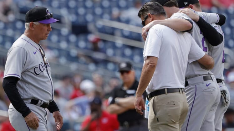 May 29, 2022; Washington, District of Columbia, USA; Colorado Rockies starting pitcher Kyle Freeland (21) is helped off the field after being injured against the Washington Nationals as Rockies manager Bud Black (10) looks on during the sixth inning at Nationals Park. Mandatory Credit: Geoff Burke-USA TODAY Sports
