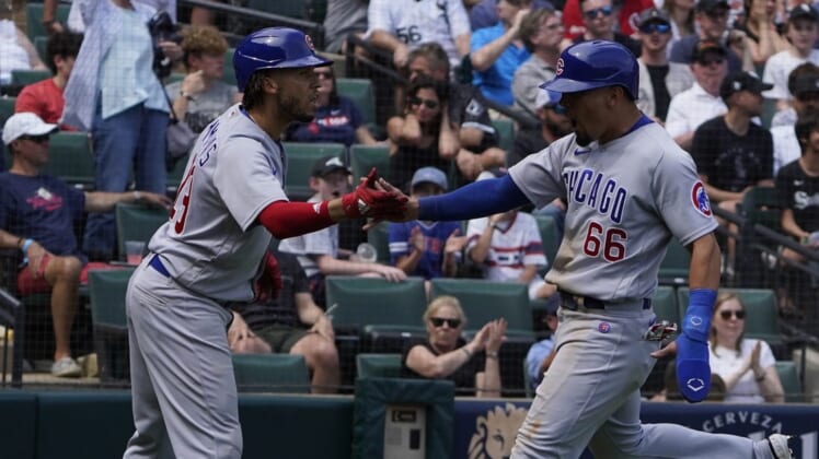 May 29, 2022; Chicago, Illinois, USA; Chicago Cubs left fielder Rafael Ortega (66) is greeted by second baseman Andrelton Simmons (19) after scoring following a fielding error against the Chicago White Sox during the seventh inning at Guaranteed Rate Field. Mandatory Credit: David Banks-USA TODAY Sports