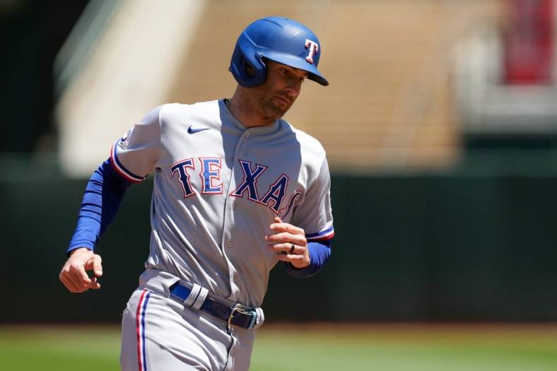 May 29, 2022; Oakland, California, USA; Texas Rangers left fielder Brad Miller (13) rounds the bases after hitting a home run against the Oakland Athletics during the third inning at RingCentral Coliseum. Mandatory Credit: Darren Yamashita-USA TODAY Sports