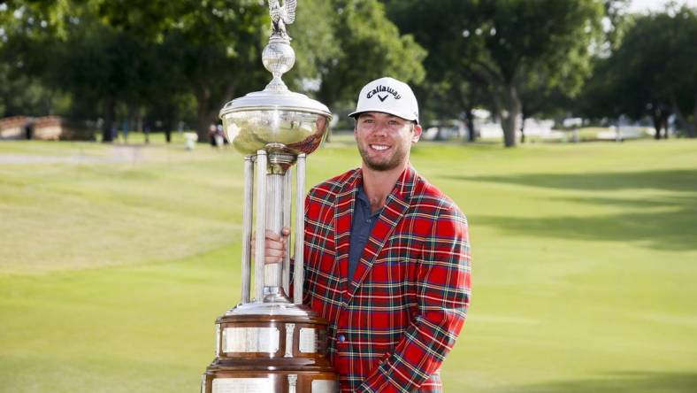 May 29, 2022; Fort Worth, Texas, USA; Sam Burns holds the winners trophy after winning the Charles Schwab Challenge golf tournament in a playoff over Scottie Scheffler. Mandatory Credit: Raymond Carlin III-USA TODAY Sports