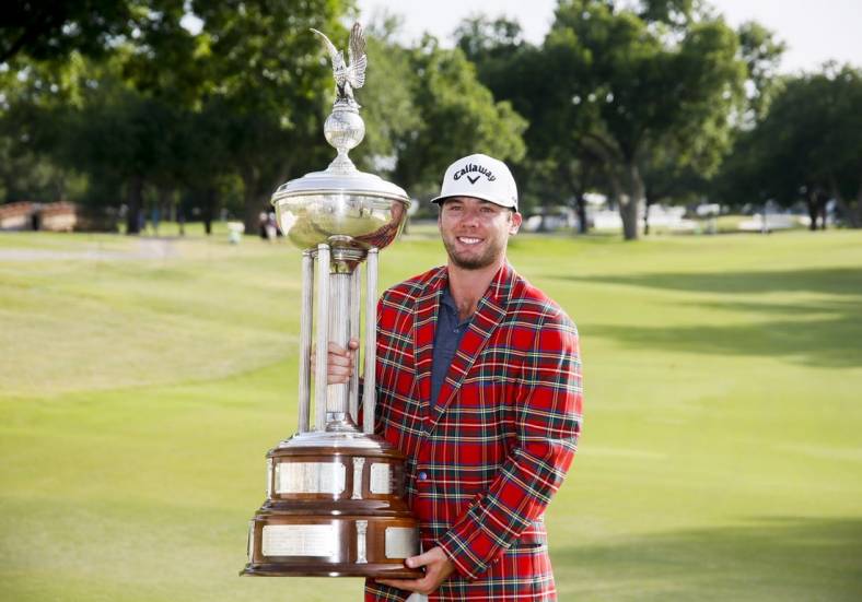 May 29, 2022; Fort Worth, Texas, USA; Sam Burns holds the winners trophy after winning the Charles Schwab Challenge golf tournament in a playoff over Scottie Scheffler. Mandatory Credit: Raymond Carlin III-USA TODAY Sports