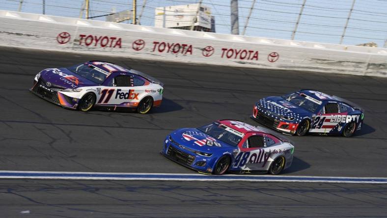 May 29, 2022; Concord, North Carolina, USA; NASCAR Cup Series driver Denny Hamlin (11) races NASCAR Cup Series driver Alex Bowman (48) and NASCAR Cup Series driver William Byron (24) during the Coca-Cola 600 at Charlotte Motor Speedway. Mandatory Credit: Jasen Vinlove-USA TODAY Sports