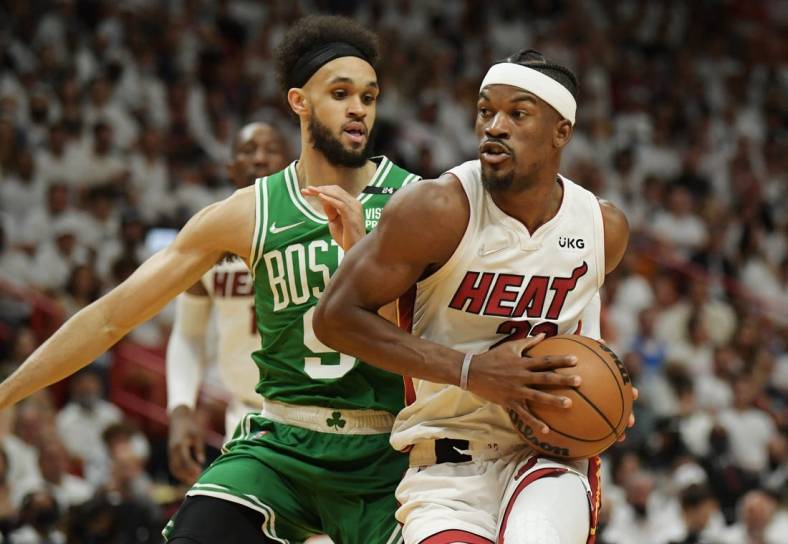 May 29, 2022; Miami, Florida, USA; Miami Heat forward Jimmy Butler (22) drives to the basket against Boston Celtics guard Derrick White (9) during the first half of game seven of the 2022 eastern conference finals at FTX Arena. Mandatory Credit: Jim Rassol-USA TODAY Sports