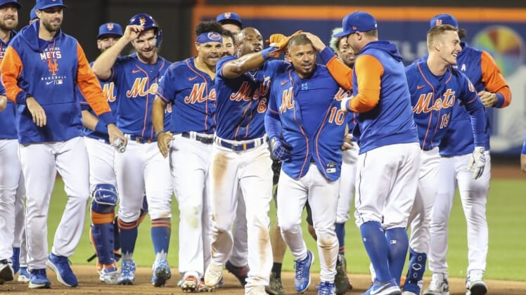 May 29, 2022; New York City, New York, USA;  New York Mets third baseman Eduardo Escobar (10) celebrates with his teammates after hitting a game winning RBI double to beat the Philadelphia Phillies 5-4 in ten innings at Citi Field. Mandatory Credit: Wendell Cruz-USA TODAY Sports